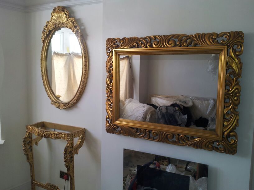 Tall bespoke full-length Mirror TV fitted to an exposed brick wall in a barbershop